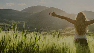 Empowered woman basking under mountain